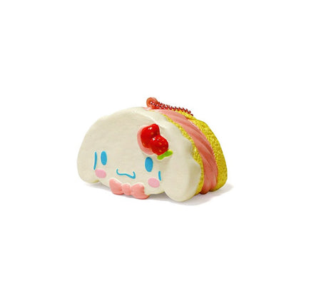 "Cinnamoroll-themed squishies including a donut, cake slice, cream puff, and waffle, each designed with pastel colors and cute character details. Packaged in original Sanrio 2017 packaging, showcasing the soft, textured surface and collectible charm."