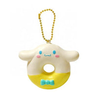 "Cinnamoroll-themed squishies including a donut, cake slice, cream puff, and waffle, each designed with pastel colors and cute character details. Packaged in original Sanrio 2017 packaging, showcasing the soft, textured surface and collectible charm."