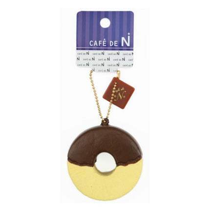 Cafe de N Chocolate Fondue Pineapple squishy in original packaging, shaped like a realistic pineapple dipped in either dark or white chocolate; features glossy drizzle detail, textured surface, and comes with a tag for authenticity.