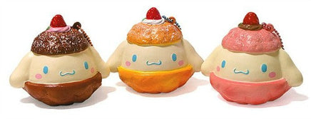 "Cinnamoroll-themed squishies including a donut, cake slice, cream puff, and waffle, each designed with pastel colors and cute character details. Packaged in original Sanrio 2017 packaging, showcasing the soft, textured surface and collectible charm."