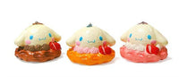 "Cinnamoroll-themed squishies including a donut, cake slice, cream puff, and waffle, each designed with pastel colors and cute character details. Packaged in original Sanrio 2017 packaging, showcasing the soft, textured surface and collectible charm."
