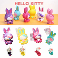 "Sanrio Hello Kitty squishy wearing a pastel bunny costume, shown in original packaging with pink ball chain and red authenticity sticker — rare collectible produced between 1976 and 2010."