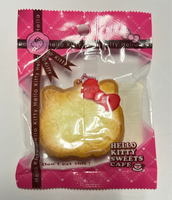 RARE Hello Kitty Sweets Cafe bread squishy shaped like a golden loaf with Hello Kitty details, packaged in original wrap with pink ball chain and red Sanrio authenticity sticker; vintage 1976–2010 collectible with possible age-related wear.