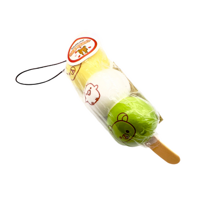 Super rare Rilakkuma Dango squishy featuring three pastel mochi-style balls on a skewer with Rilakkuma’s face, shown in original packaging with tag; vintage item with possible signs of age like cracks or imperfections.
