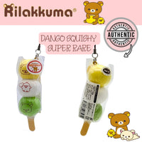 Super rare Rilakkuma Dango squishy featuring three pastel mochi-style balls on a skewer with Rilakkuma’s face, shown in original packaging with tag; vintage item with possible signs of age like cracks or imperfections.