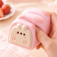 Bunny Paw Cake Roll Squishy with 3D pink bunny paw design, strawberry cream scent, slow-rising kawaii stress relief toy in clear display box.