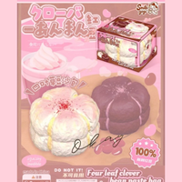Four Leaf Clover Bean Paste Bun Squishy in white featuring realistic bakery texture, scented slow-rising foam, displayed in a clear protective collector box for kawaii décor and stress relief.