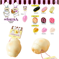 Cafe Sakura Super Squishy Series featuring Vanilla Bread Roll, Chocolate Roll Cake, Vanilla Éclair, and Chocolate Éclair with original packaging, tags, and pink ball chain rare collectibles.