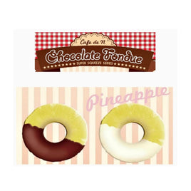 Cafe de N Chocolate Fondue Pineapple squishy in original packaging, shaped like a realistic pineapple dipped in either dark or white chocolate; features glossy drizzle detail, textured surface, and comes with a tag for authenticity.