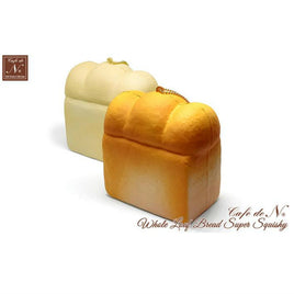 Cafe de N Bakery Bread Squishy in two color variations, 4x4 inches, soft and slow rising with a realistic bread texture, shown with original licensed tag, released May 2017.