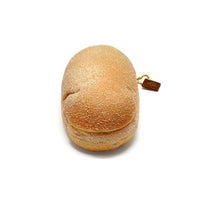 Cafe de N Bakery Koppe Pan squishy, realistic bread roll design measuring 5 by 2.5 inches, light golden-brown color with original 2017 packaging and product tag, soft slow-rising texture.